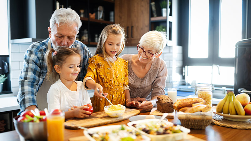 grandparents with grandchildren at kitchen island retirement strategies portsmouth nh