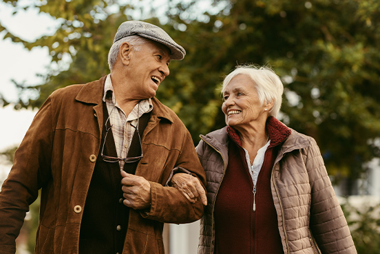 senior couple in fall jackets walking and smiling together what is an annuity portsmouth nh