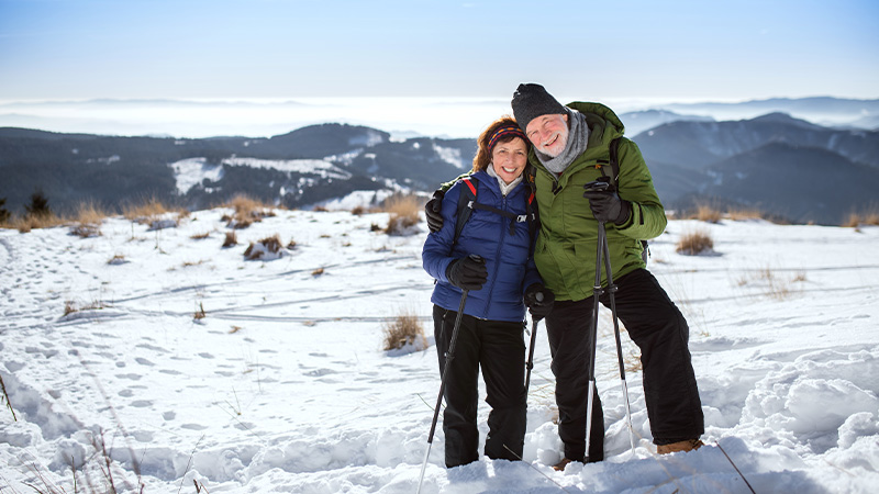 couple hiking in winter with mountains in the background benefits of an fia portsmouth nh